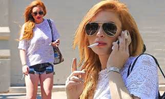 Lindsay Lohan Shows Off Her Healthy Frame In Daisy Dukes While Puffing