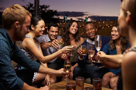 Group Of Friends Enjoying Night Out At Rooftop Bar Stock Image Image Of Alcohol African 67525701