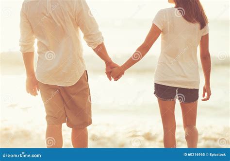 Young Couple Holding Hands On The Beach At Sunset Stock Image Image Of Holidays Marriage