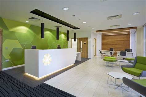 reception area with green wall clinic interior design hospital interior design healthcare