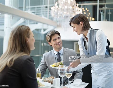 Waitress Serving Food To Couple In Restaurant High-Res Stock Photo - Getty Images