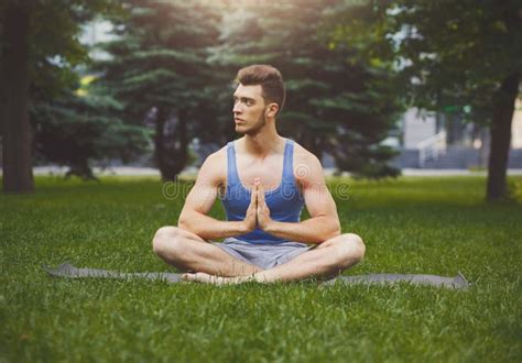 Young Man Practicing Yoga Sitting In Padmasana Stock Image Image Of