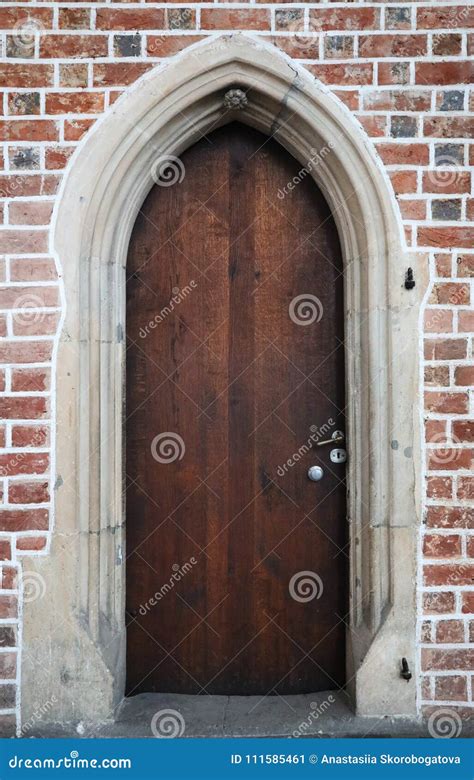 Wooden Gothic Doors In A Brick Wall Stock Image Image Of Bricks