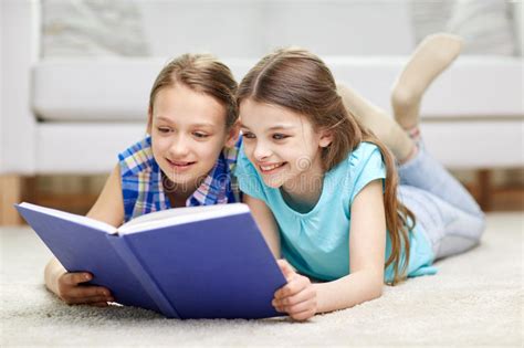 Two Happy Girls Reading Book At Home Stock Photo Image Of Offsprings