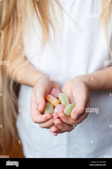 Little Girl Holding Sweet Candies In Her Hands Stock Photo Alamy