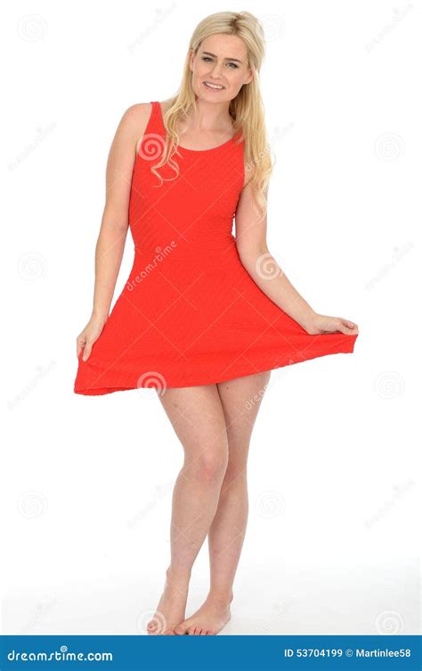 Attractive Playful Young Blonde Woman Wearing A Short Red Mini Dress