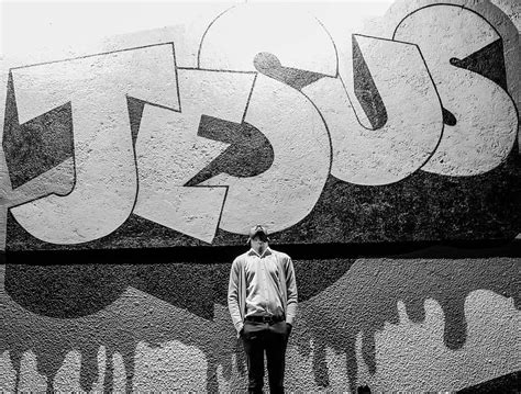 Grayscale Graphy Of A Man Standing In Front Of A Jesus Graffiti Hd