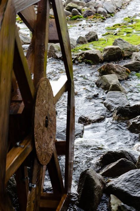 Wooden Grist Mill Water Wheel Turning With The Flow Of Water Closeup