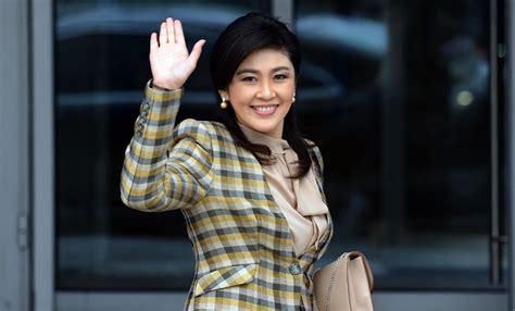 thai prime minister yingluck shinawatra waves as she arrives to attend the asia pacific economic