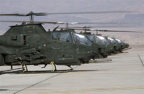 A Row Of Us Army Ah 1s Cobra Helicopter Are Parked On The Flight Line