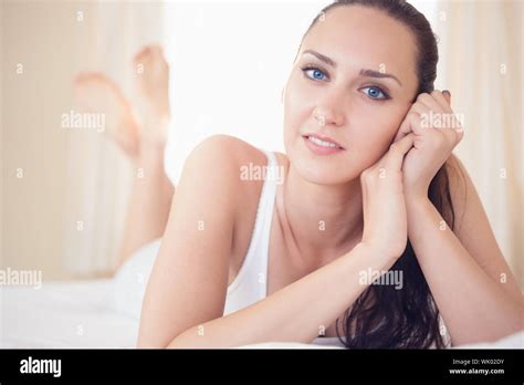 Peaceful Brunette Lying On Bed And Smiling Stock Photo Alamy