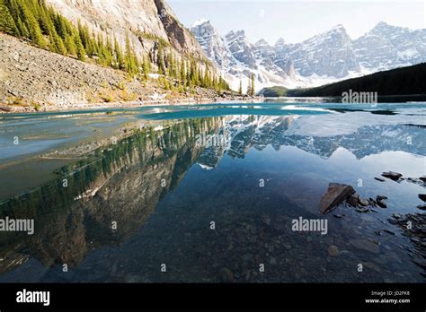 Mountains Reflecting In The Surface Of Moraine Lake In The Canadian