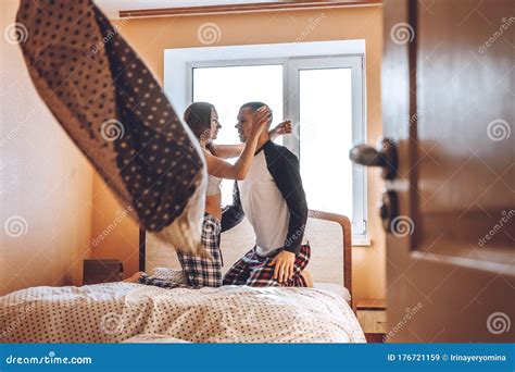 Happy Young Couple Is Having Fun In Bed In New Empty Home Enjoying The