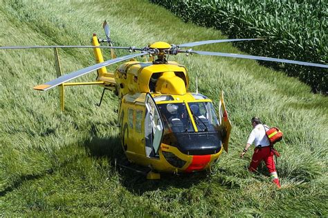 Man Walking Yellow Red Helicopter Daytime Rescue Helicopter Fly