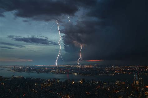 Large Lightning Strikes Coming From The Clouds Into The City Nyc