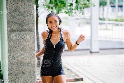 A Young Chinese Asian Teenager Girl Takes A Shower During The Day In