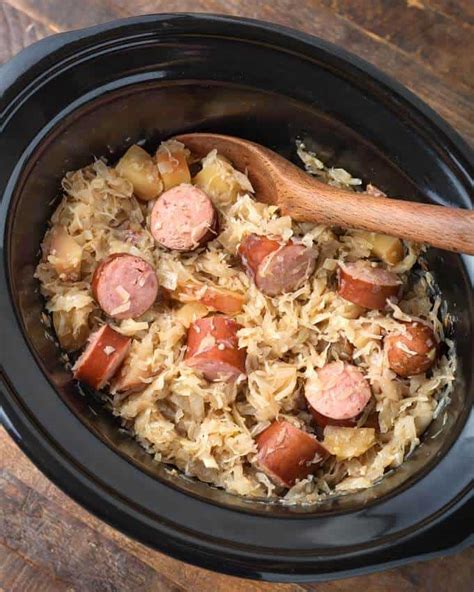 Place the chicken and onion in the slow cooker. Slow Cooker Sauerkraut and Kielbasa | Simply Happy Foodie
