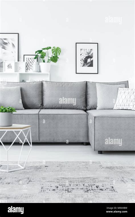 Cropped Photo Of Grey Corner Couch And Modern Coffee Table In A White