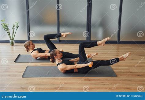 Uses Dumbbells Two Women In Sportive Wear And With Slim Bodies Have Fitness Yoga Day Indoors