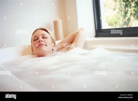 Let your stress melt away. A happy young woman relaxing in a luxurious