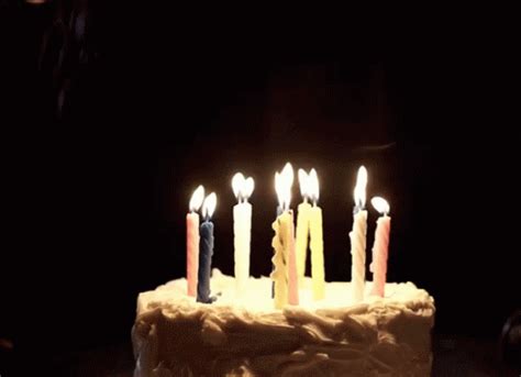 A Birthday Cake With Lit Candles On It