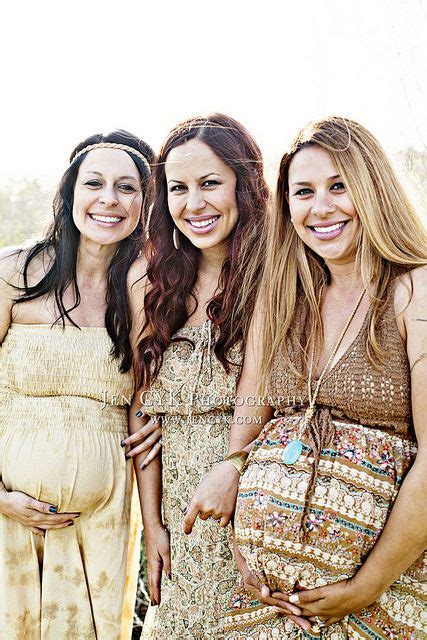 Three Beautiful Women Standing Next To Each Other In Front Of The Camera With Their Pregnant