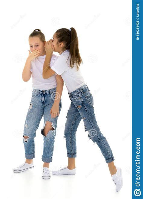 Two Cheerful Little Girls Share Secrets In Each Other S Ear Stock