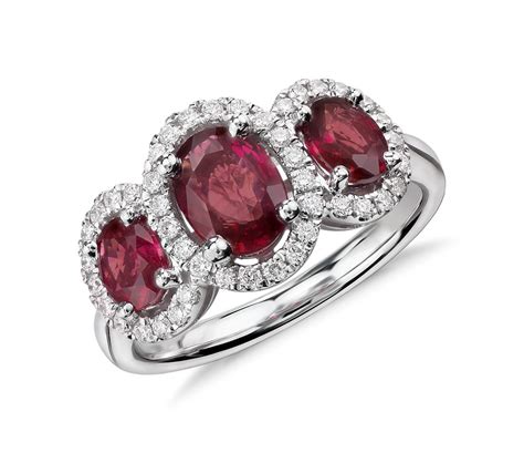 Use the table below to see your ring size, if it falls in the middle of two sizes, pick the larger one. 3-Stone Oval Ruby and Diamond Halo Ring in 18k White Gold (7x5mm) | Blue Nile