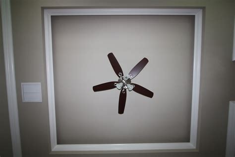 I have seen interior designers cringe at the mention of the term 'ceiling fan'. Ceiling fan surrounded by two layers crown molding ...