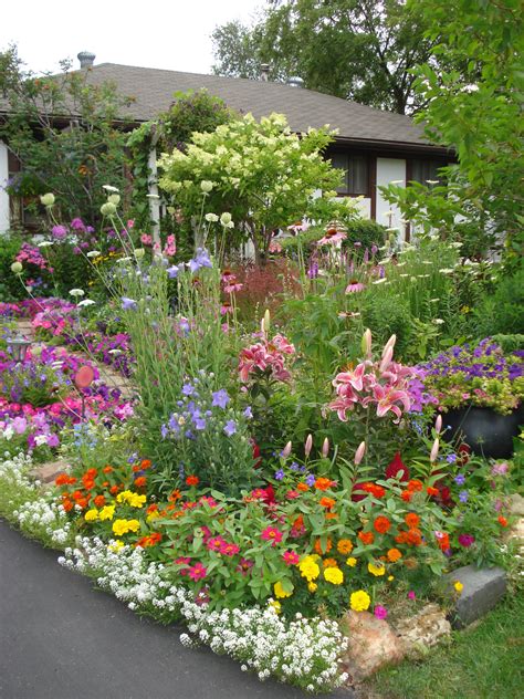 Some Of The Flowers In Front Yard Next To The Driveway By The Street