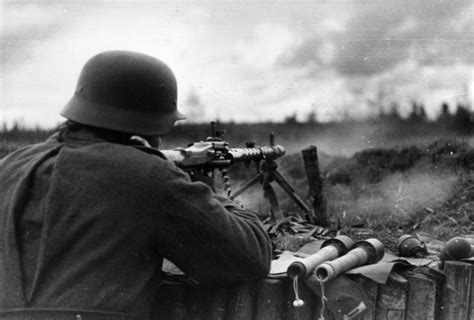 A German Machine Gunner In Action With An Mg34 And Several Hand