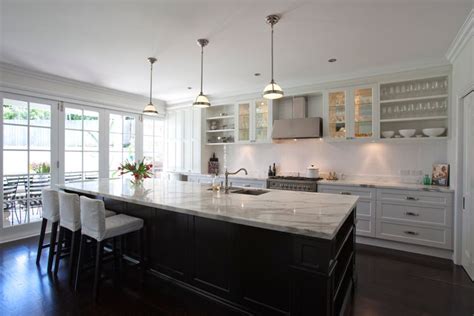 Traditional dining side chairs and clerestory window white countertop. Galley kitchen with large island bench | Kitchen Ideas ...