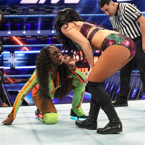 Photos Asuka Pounces On The IIconics To Save Naomi From Post Match