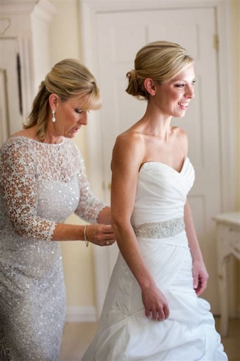 Mother Helping Bride In Dress