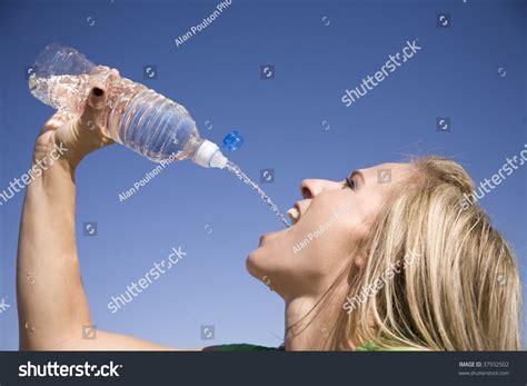Woman Squirting Water Bottle Into Her Stock Photo Shutterstock