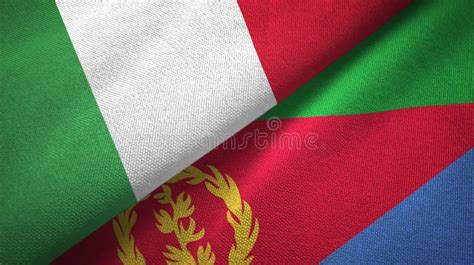 Italy And Eritrea Two Flags On Flagpoles And Blue Cloudy Sky Stock