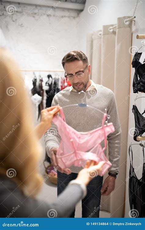 Woman Showing A Set Of Pink Underwear To Her Husband Stock Photo Image Of Glad Cheerful