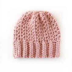 A Pink Knitted Hat On A White Background