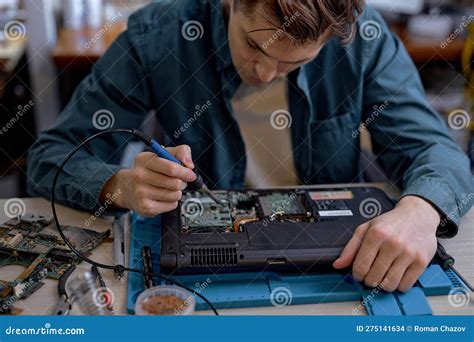 Concentrated Man Replacing Details In Computer Repair Workshop
