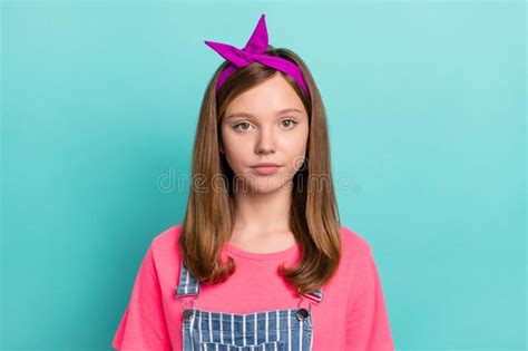 Photo Of Serious Brown Hairdo Small Girl Wear Headband Pink T Shirt Isolated On Teal Color