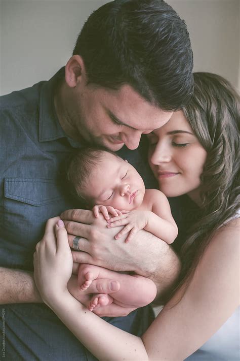 New Family Together Mother And Father Hugging Their Baby By Stocksy Contributor Lea Csontos