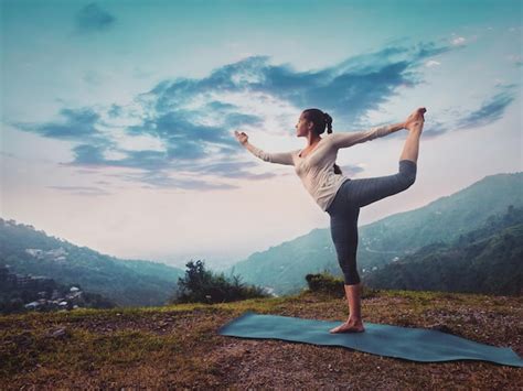 Premium Photo Woman Doing Yoga Asana Natarajasana Outdoors On Sunset