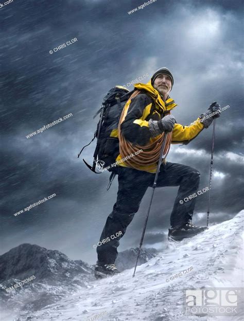 Caucasian Man Climbing Snowy Mountain Stock Photo Picture And Royalty