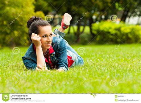 Pretty Girl In Blue Jeans Lying On A Grass Stock Image Image Of