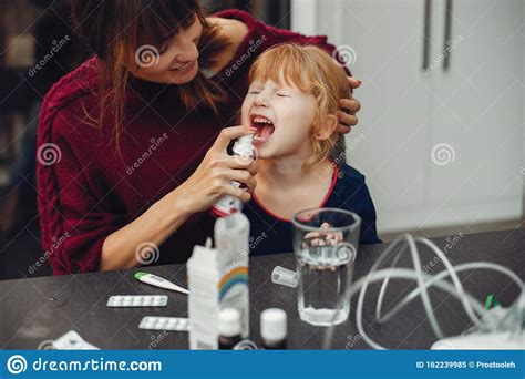 mother treats her daughter at home stock image image of check blue 162239985
