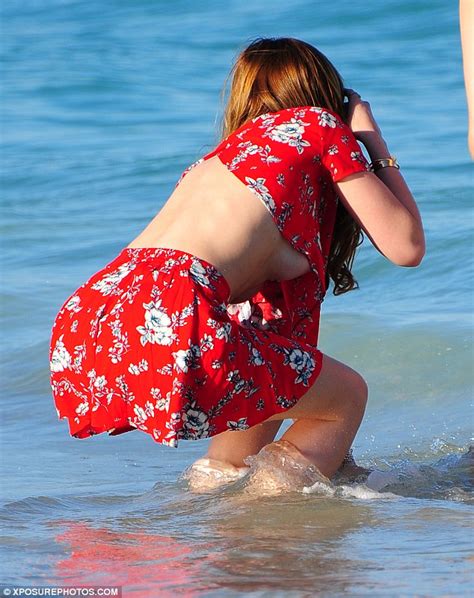 Bella Thorne Shows Off Her Taut Tum As She Hits The Beach With Sister
