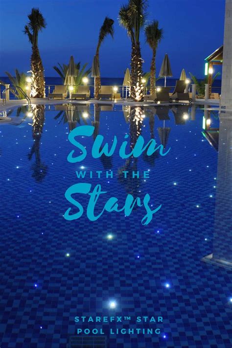 The Swimming Pool Is Lit Up At Night With Palm Trees In The Background And Words Saying Swim