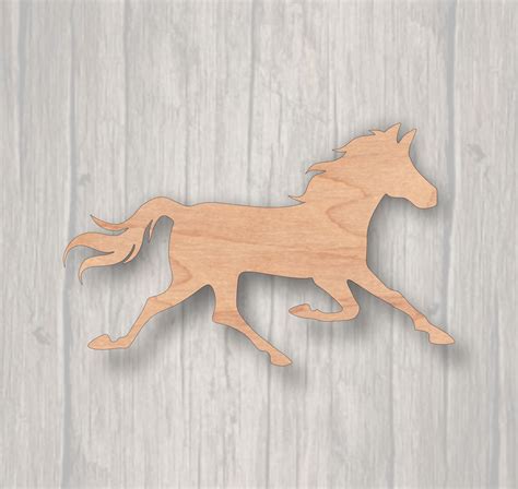 A Wooden Cutout Of A Galloping Horse On A Wood Background With The Text