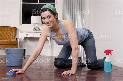 Housekeeper Smiling On All Fours Wearing Kneepads Scrubbing The Floor