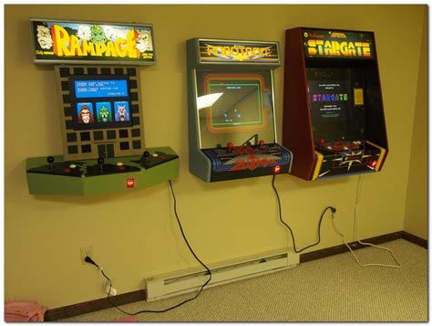 Two Arcade Machines Sitting Next To Each Other On The Floor In Front Of